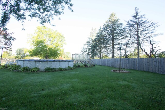 view of yard with a fenced in pool