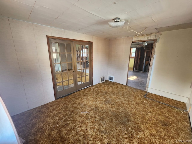 carpeted spare room with french doors