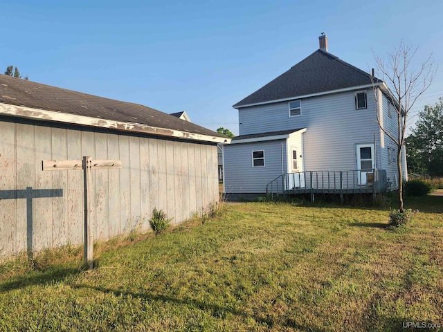 back of house with a yard and a wooden deck