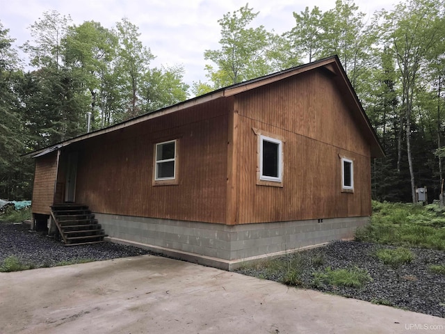 view of property exterior featuring crawl space and a patio