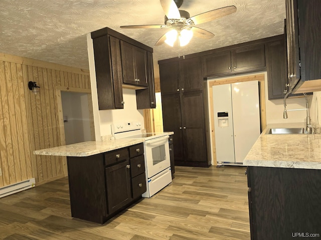 kitchen featuring white appliances, light countertops, and wood finished floors