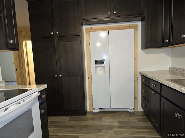 kitchen with white appliances, light countertops, and dark wood-type flooring