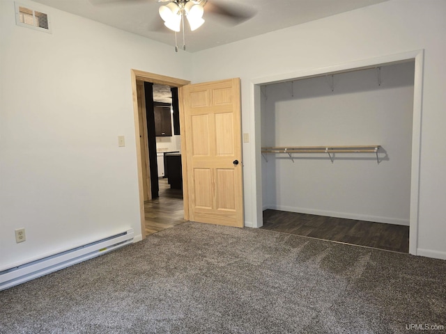 unfurnished bedroom featuring carpet, a baseboard radiator, a closet, visible vents, and ceiling fan