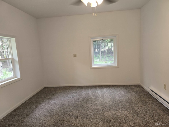 unfurnished room with a baseboard heating unit, ceiling fan, carpet, and baseboards