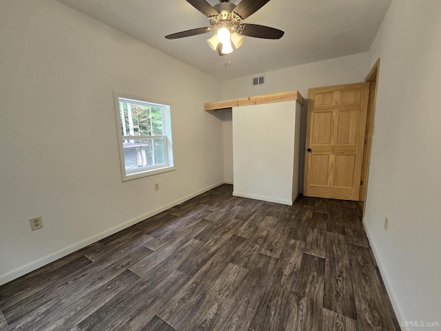 unfurnished bedroom featuring a closet, visible vents, dark wood-type flooring, ceiling fan, and baseboards