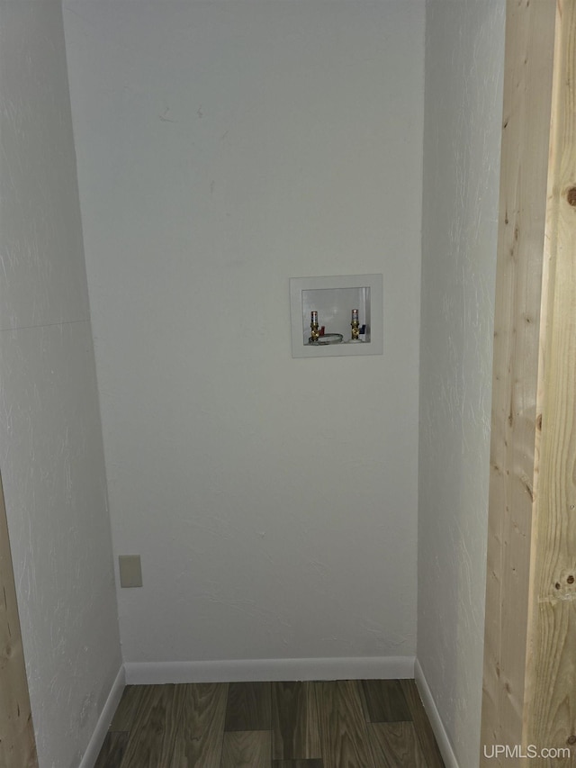 clothes washing area with laundry area, baseboards, washer hookup, and wood finished floors