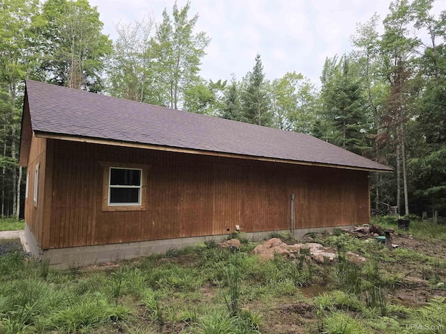 view of property exterior featuring a shingled roof