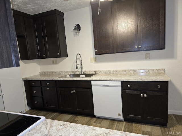 kitchen with dark wood finished floors, light countertops, white dishwasher, and a sink