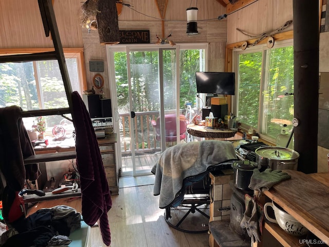 sunroom featuring vaulted ceiling with beams