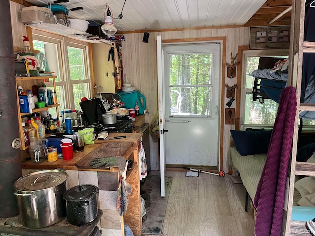 kitchen with wooden ceiling, wood-type flooring, and wood walls