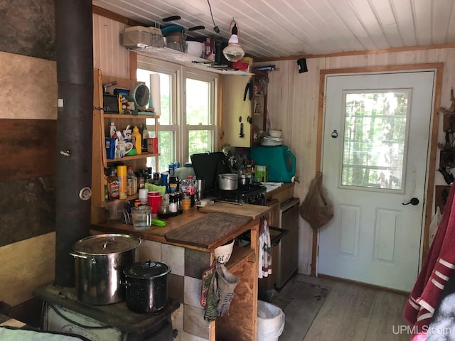 kitchen featuring wood walls, light hardwood / wood-style floors, and wooden ceiling