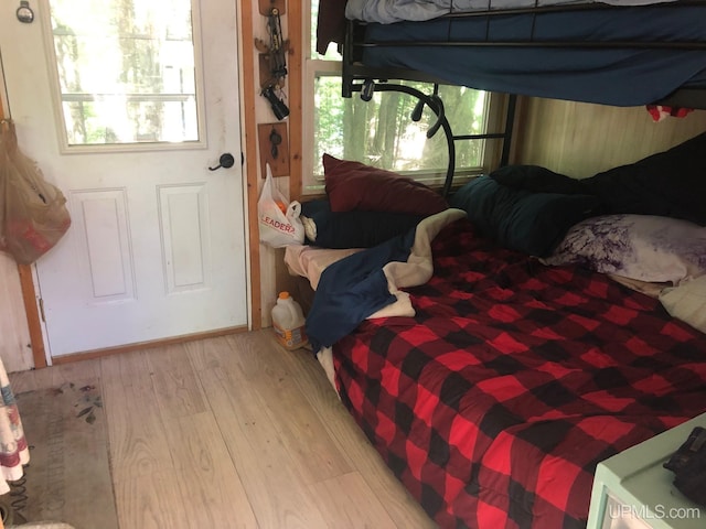 bedroom with multiple windows and light hardwood / wood-style floors