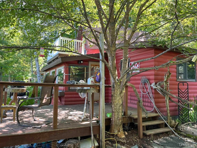 rear view of house featuring a wooden deck