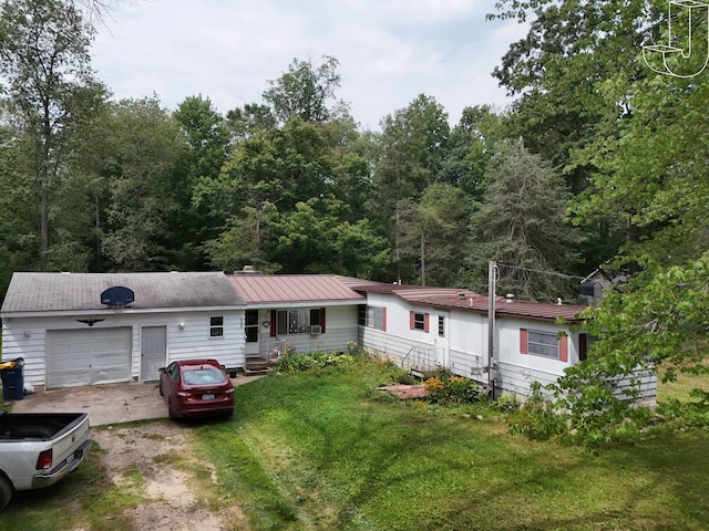 view of front of property with a garage and a front yard