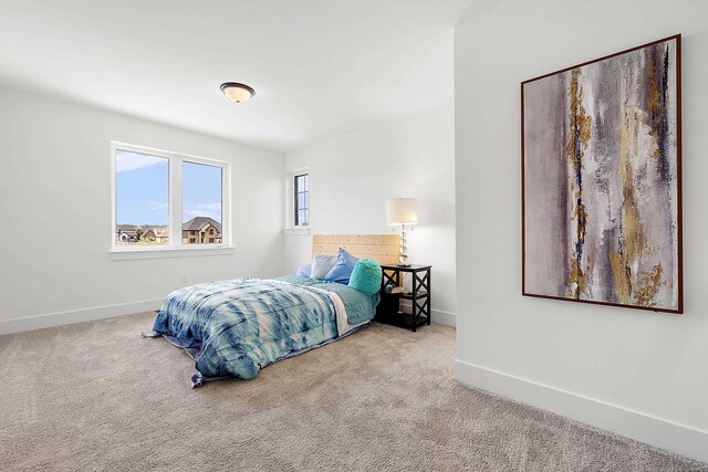 bedroom with light colored carpet