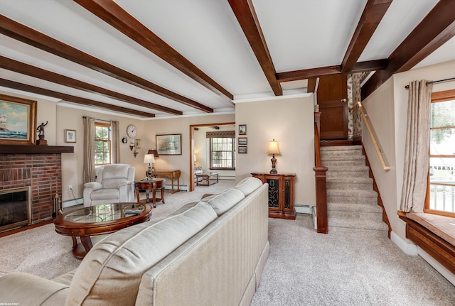 living room with a brick fireplace, a healthy amount of sunlight, and beam ceiling