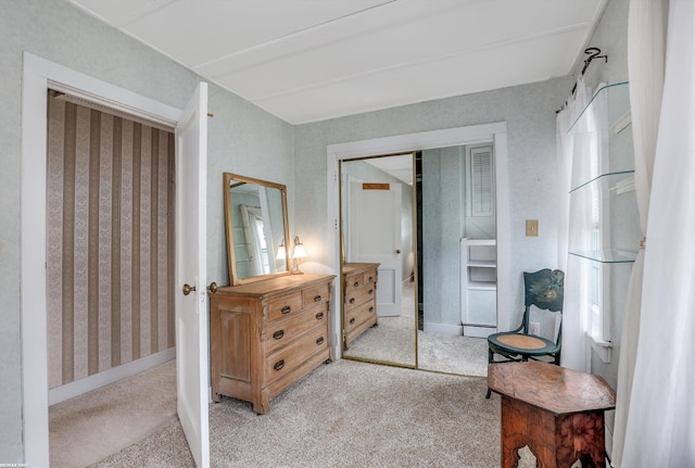 bedroom with light carpet and baseboards