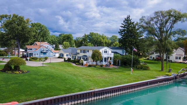 rear view of property with a yard