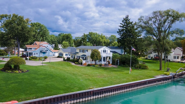 back of property with a residential view and a yard