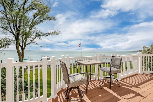 wooden terrace featuring a water view