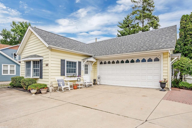 view of front of home featuring a shingled roof, driveway, and an attached garage