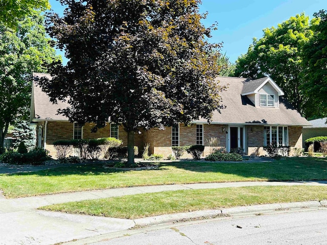 new england style home with a front yard