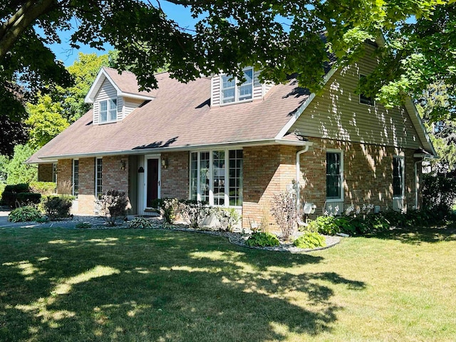 cape cod home with a front yard