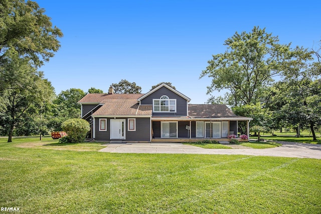 view of front of home with a porch and a front yard