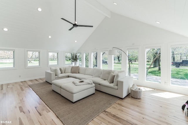 living room with ceiling fan, high vaulted ceiling, light hardwood / wood-style flooring, and beamed ceiling