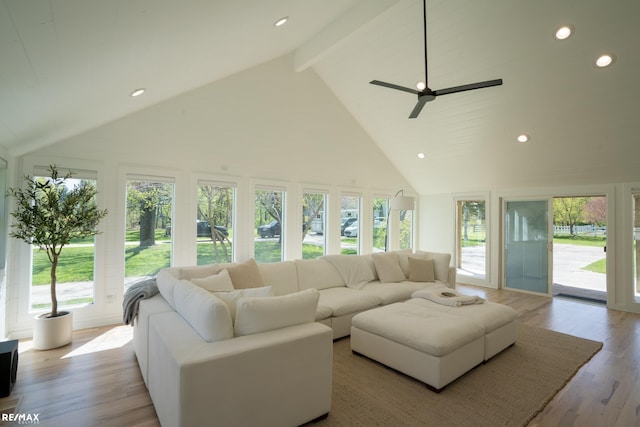 living room with ceiling fan, beam ceiling, high vaulted ceiling, and light hardwood / wood-style flooring