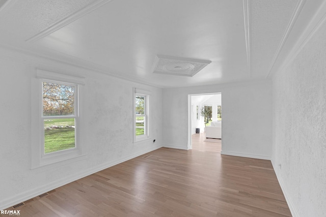 spare room with hardwood / wood-style floors and ornamental molding