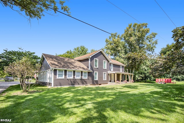 view of side of home with a lawn