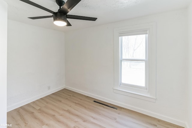 spare room with light hardwood / wood-style flooring and ceiling fan