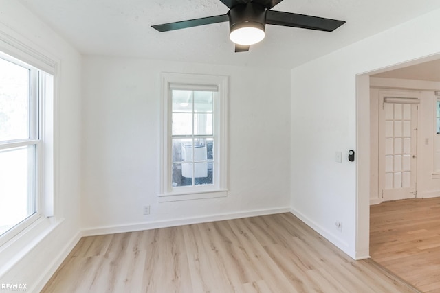 spare room with light hardwood / wood-style floors and ceiling fan