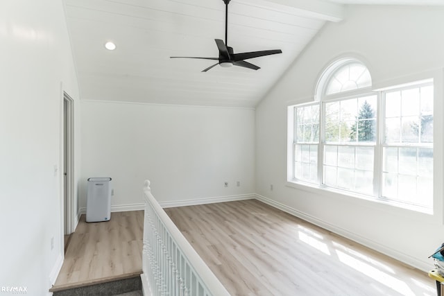 additional living space with ceiling fan, light wood-type flooring, and lofted ceiling with beams