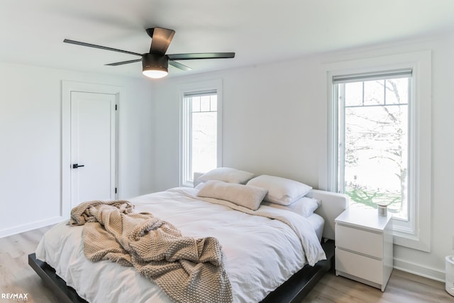 bedroom featuring ceiling fan and light hardwood / wood-style floors