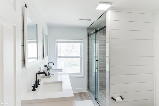 bathroom featuring decorative backsplash, a shower with door, hardwood / wood-style floors, and vanity