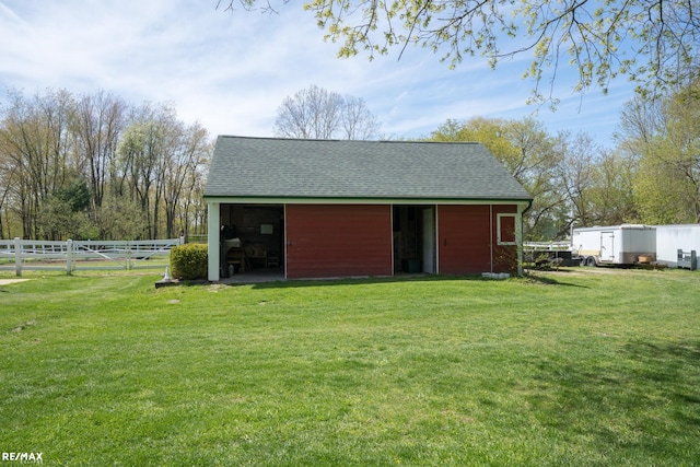 view of outbuilding featuring a lawn