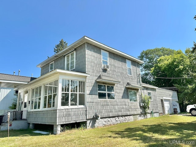 back of property with cooling unit, a sunroom, and a yard