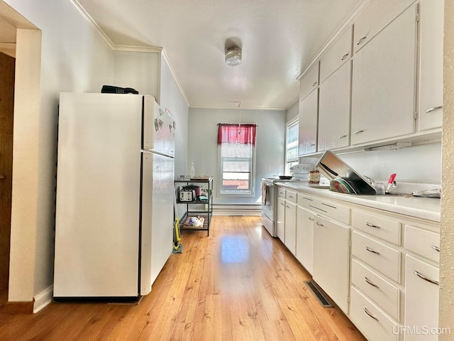 kitchen featuring light wood-type flooring, white cabinetry, and white appliances