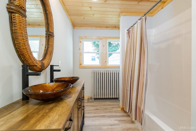 bathroom featuring vanity, wooden ceiling, hardwood / wood-style flooring, shower / bathtub combination with curtain, and radiator heating unit