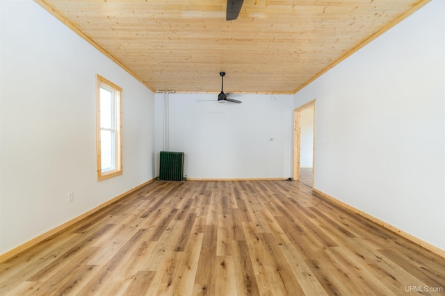 spare room featuring light wood-type flooring, ceiling fan, wood ceiling, and radiator heating unit