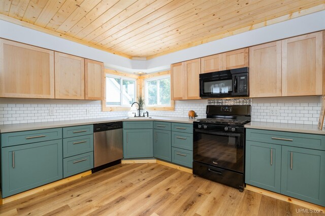 kitchen with black appliances, light brown cabinetry, and light hardwood / wood-style floors