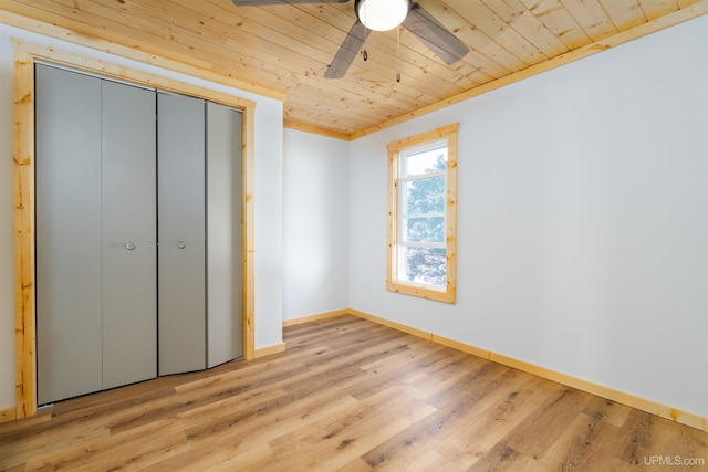 unfurnished bedroom featuring wood ceiling, light hardwood / wood-style flooring, ceiling fan, and a closet