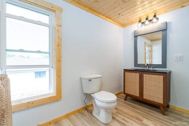 bathroom with vanity, toilet, ornamental molding, and hardwood / wood-style flooring