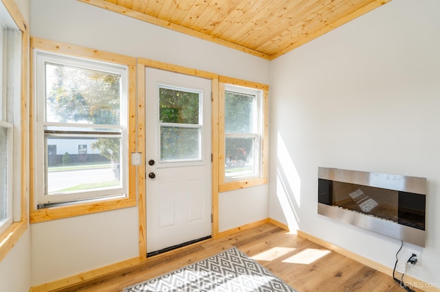 doorway featuring light hardwood / wood-style floors and wooden ceiling