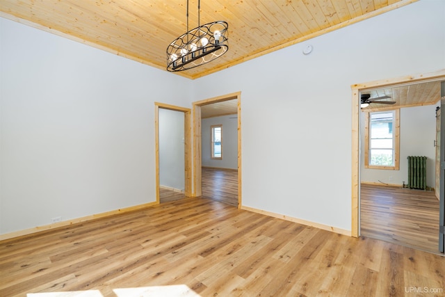 empty room featuring light wood-type flooring, crown molding, ceiling fan with notable chandelier, radiator heating unit, and wooden ceiling