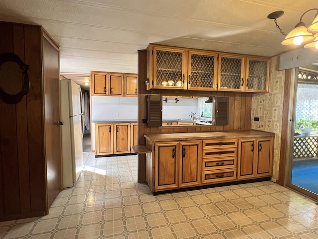 bar with light floors and freestanding refrigerator