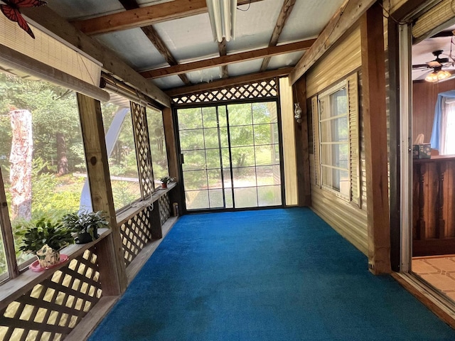 unfurnished sunroom with a ceiling fan