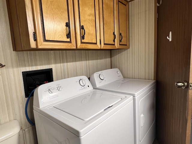 laundry room with laundry area, wallpapered walls, and washer and dryer